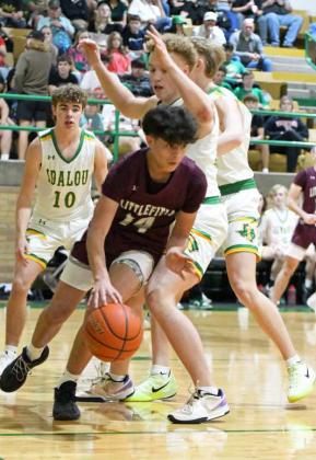 Littlefield’s Ben Castillo dribbles out from under the basket and finds Ryan Williams at the top of the key for a three, during the first half of the Wildcats’ road victory over Idalou on Friday. (Staff Photo by Derek Lopez)
