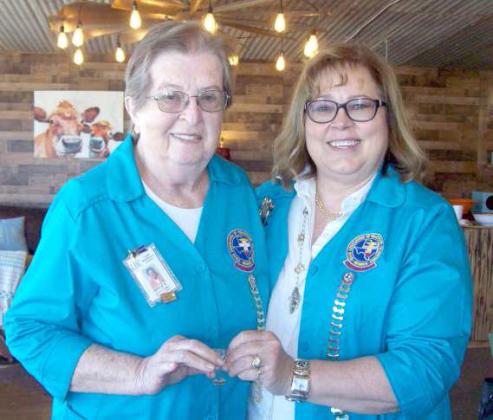 Gayle Heckard received her 400 hour bar presented by Lori Durham.