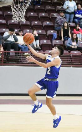 FINISHING AT THE RIM –Olton guard, Jake Soliz (2), finishes off a fast-break with a lay-up, during the Mustangs’ Wildcat Classic semi-final victory over the host team Wildcats in overtime on Wednesday, 63-60. (Staff Photo by Derek Lopez)