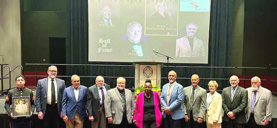 Bonnie Anderson, (center in pink jacket) longtime Littlefield High School band director, is inducted into the Phi Beta Mu Texas Bandmasters Hall of Fame after a 32-year career leading the Marchin’ Cats. (Submitted Photos)