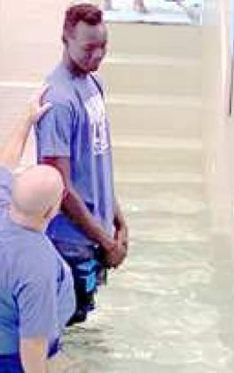 Rev. Donnie Brown 5-5, prepares to baptize Deng Bol Yol, 6-11 Wayland Baptist University basketball player.