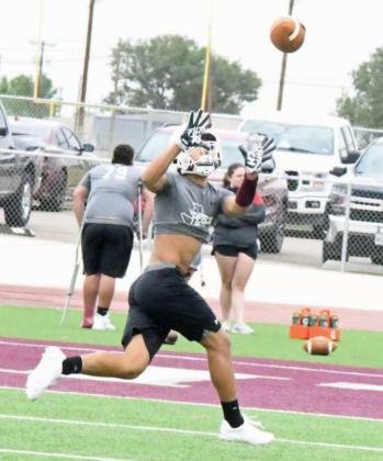 CATCHING IN STRIDE – Littlefield’s Javen Jimenez catches a ball from his quarterback in stride to the end zone during route running drills, during the Wildcats’ first day of two-a-days on Monday. (Staff Photo by Derek Lopez)