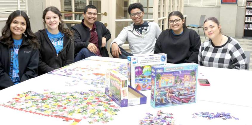 Monica Elizondo, Madison Brown,Jimmy Ramos, Jordan Randle, Kali Cornette, and Anais Osmenaj having fun but not making a lot of progress on a jigsaw puzzle at the Lamb County Library Pajama Party hosted by the Lamb County Library on Thursday January 30, 2025. (Photo by Ann Reagan)