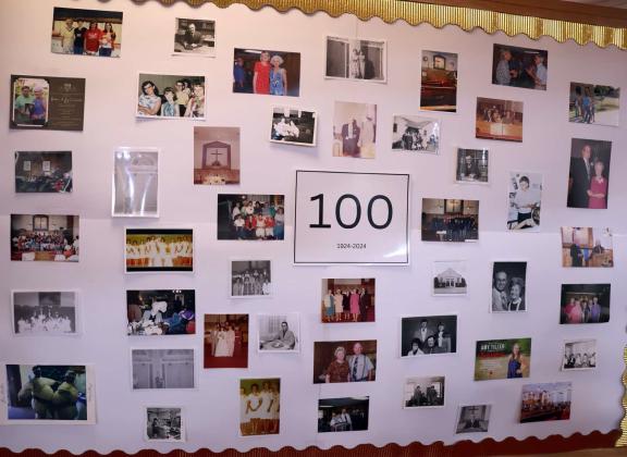 This bulletin board displayed many memorable photos depicting the past members of the First Baptist Church of Amherst from the past 100 years. (Photo by Ann Reagan)