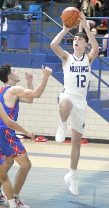 Brady Azam goes up for a floater from the left side, during the first half of the Olton Mustang’s, 61-39, victory over Sundown last Tuesday at Musatngs Gym. (Staff Photo by Derek Lopez)