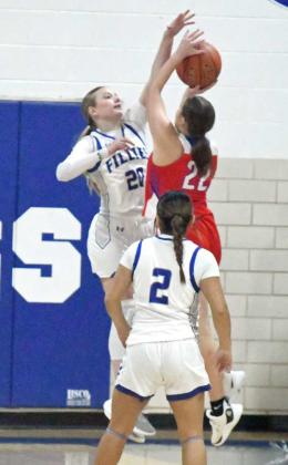 Olton’s Analise Ramage goes up and delivers a block against Sundown, during the first half of the Fillie’s, 70-40, loss to Sundown last Tuesday at Musatngs Gym. (Staff Photo by Derek Lopez)