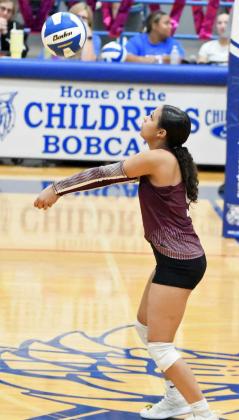 Littlefield’s Madi Williams, bumps a ball up in the air, as the Lady Cats looked to go on the offensive against Childress, during their road district match-up on Tuesday. (Staff Photo by Derek Lopez)