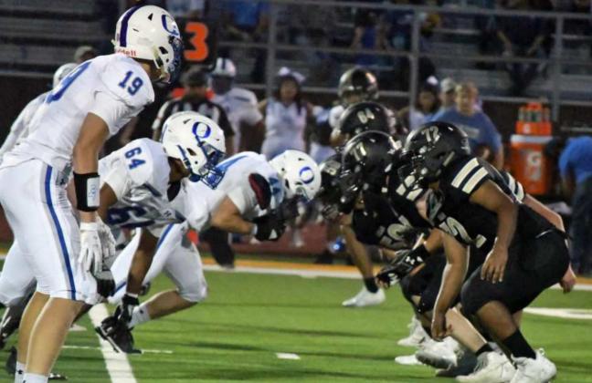 BATTLE IN THE TRENCHES – The Olton Mustang’s front seven fire off the ball on defense, looking to penetrate the Sudan offensive line and make a play in the backfield, during the second half of their contest on Friday in Sudan. (Staff Photo by Derek Lopez)