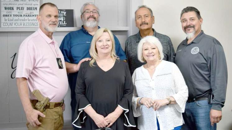 FELLOW PROBATION OFFICERS -- Carrie Barden, in center, is pictured with her fellow area Probation Officers that she served with through the 40 years she served as the Lamb County Chief Juvenile Probation Officer. Left to right: Sid Felon- Bailey and Parmer County, Reba Moore- Floyd, Motley, Dickens and Brisco Counties, Norm Moore- Hockley County, and Scott Winn- Hockley County. (Photo by Ann Reagan)