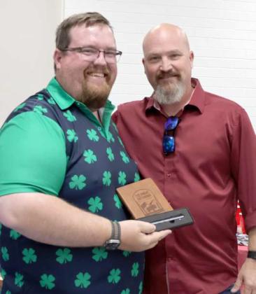 Terry Sanders, right, received the Distinguished LeaderAward from Brandon Albus for reorganizing the 4-H Archery Program during the Lamb County 4-H Banquet. (Photo by Ann Reagan)