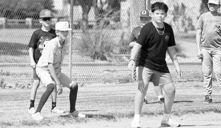 Campers during the afternoon session work on base running from third base on Thursday at the Olton Youth Baseball Camp. (Staff Photo by Derek Lopez)