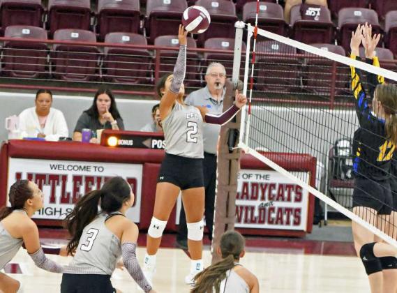 Littlefield’s Cali Saldana (2), drops in a tip over the Wellman-Union blockers for a kill, during the Lady Cats tournament-opener at their tournament this past weekend at Wildcat Gymnasium (Staff Photo by Derek Lopez)