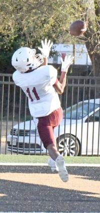 Littlefield’s Zane Champion, catches a touchdown pass from Nate Castaneda on Friday, during the Wildcats’ first scrimmage of the season on the road against Post. (Staff Photo by Derek Lopez)