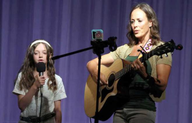 11-year-old, Lucy Carroll, accompanied by Tony Meredith performed during intermission at the Sandhills Sweetheart Pageant 2025 in Olton, TX. (Photo by Ann Reagan)