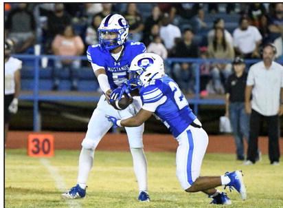 Olton senior quarterback, Raymond Ramirez, hands the ball off to senior running back, Nathaniel Ruiz, late in the game on Friday, as the Mustangs took down Sudan, 22-15, in their season-opener at Mustang Stadium.