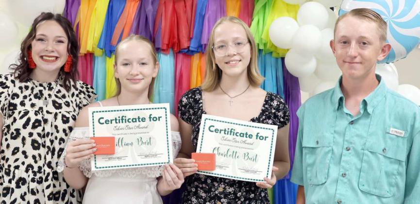 Claire Lostroh, left, and Ryan Muller, far right, presented the Silver Star Awards to Lillian Burt, and Charlotte Burt during the Annual 4-H Banquet. (Photo by Ann Reagan)