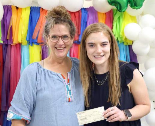 Connie Burt representing the Lamb County 4-H Adult Leaders presented a $500 Scholarship check to Senior 4-H member Brindle Harper at the Lamb County 4-H Banquet. (Photo by Ann Reagan)