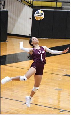 Littlefield’s Faith Balderas (1) leaps up to deliver a serve, during the Lady Cats’, 2-3, loss to the Lady Lopes last Tuesday in Post. (Staff Photo by Derek Lopez)