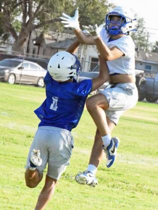 Olton’s defense works on coverage, while the receivers work on route running, during the first day of two-a-days Monday, as they prepare for the 2025 season. (Staff Photo by Derek Lopez)