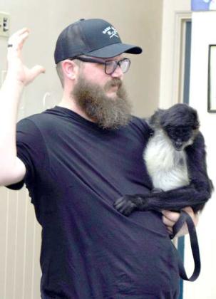Jarrod Dale of Walter’s World of Pets in Lubbock explains how Sidney the Spider Monkey uses her fifth toes to hold on to tree branches at the Lamb County Library Summer Reading program on Thursday, June 22, 2023. The theme of the week was Kindness to Animals. (Photo by Ann Reagan)