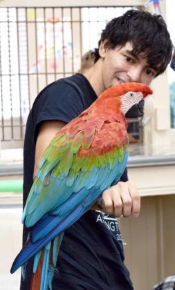 Andrew Reyes smiles as his companion, Mickie the Macaw, clearly says “Hello” to the young participants of the Lamb County Library Summer Reading Program on June 22, 2023. (Photo by Ann Reagan)