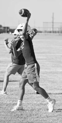 Littlefield quarterback, Sammy Saenz, warms up his arm, during the first day of two-a-days Monday morning. (Staff Photo by Derek Lopez)