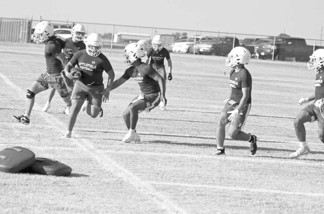 The Littlefield Wildcats’ football team works on pursuit drill, during the first day of two-a-days Monday morning. (Staff Photo by Derek Lopez)
