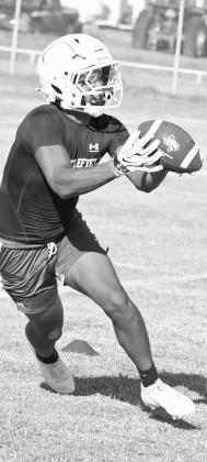 The Littlefield Wildcat, AJ Cantu catches a pass, during the first day of two-a-days on Monday morning. (Staff Photo by Derek Lopez)