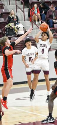 Littlefield senior, Kam McCarty (4), pulls up for a jumper from the elbow over Slaton’s Daniel Payne, during the first half of the Wildcats loss to the Tigers on Tuesday at Wildcat Gym. (Staff Photo by Derek Lopez)
