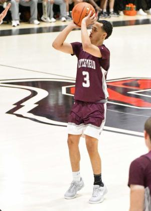 Littlefield’s Ryan Williams fires up a three from the left elbow, during the fourth quarter of the Wildcats’, 79-68, loss to the Tigers in Slaton on Tuesday for their district-opener. (Staff Photo by Derek Lopez)