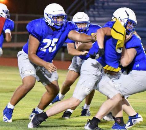 Olton’s offensive line protects the quarterback, during their Midnight Madness Intersquad scrimmage this past Friday at Mustang Stadium. (Staff Photo by Derek Lopez)