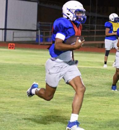 Olton senior quarterback, Raymond Ramirez, takes off on a run to the right side, during their Midnight Madness Intersquad scrimmage this past Friday at Mustang Stadium. (Staff Photo by Derek Lopez)