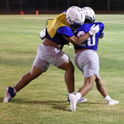 Olton’s defense wraps up the ball carrier for a short gain, during their Midnight Madness Intersquad scrimmage this past Friday at Mustang Stadium. (Staff Photo by Derek Lopez)