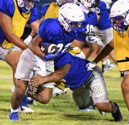 Olton’s defense gets their hands on the ball carrier and brings him to the ground, during their Midnight Madness Intersquad scrimmage this past Friday at Mustang Stadium. (Staff Photo by Derek Lopez)