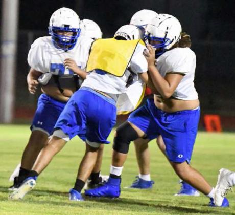 Olton’s offensive line protects the quarterback, during their Midnight Madness Intersquad scrimmage this past Friday at Mustang Stadium. (Staff Photo by Derek Lopez)