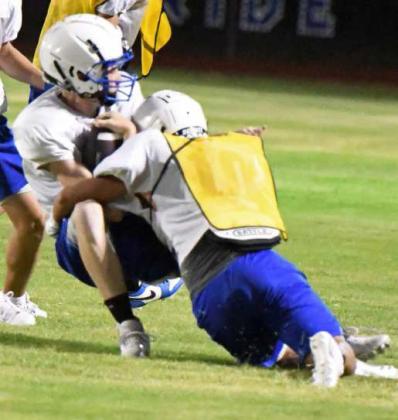 Olton’s defense brings the boom stick on a receiver, during their Midnight Madness Intersquad scrimmage this past Friday at Mustang Stadium. (Staff Photo by Derek Lopez)