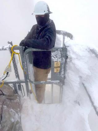 XCEL EMPLOYEE WORKING IN THE SNOW