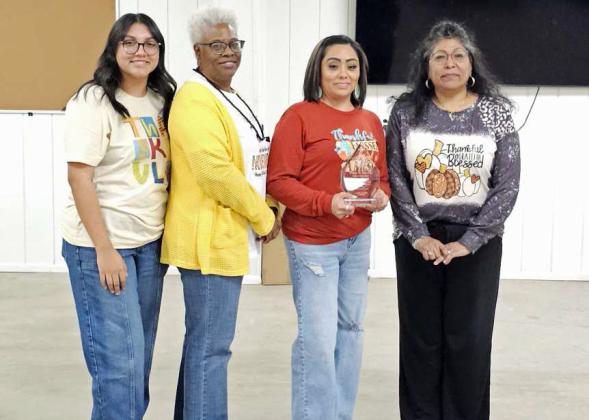 New Lamb County Clerk Rene Trevino and members of the Lamb County Clerk staff, Eva Garcia, Kandy Scales and Haylee Saenz accepted Late County Clerk Tonya Ritchie’s Retiree award at the Lamb County Thanksgiving Luncheon on Wednesday at the Lamb County Ag Center. (Staff Photo by Derek Lopez)