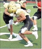 A Sudan defender makes an open field tackle, during their intersquad scrimmage Saturday night at Hornet Stadium. (Staff Photo by Derek Lopez)