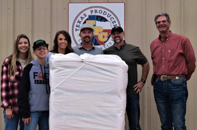 JEFF EDWARDS of Sudan produced the first bale of cotton for Texas Producers Coop in Sudan for the 2021 ginning season. Shown are Kyndal, Kooper, Jennifer and Jeff Edwards producer, with Justin Bellar, agronomy manager for Texas Producers Coop and Guyle Roberson CEO of Texas Producers Coop. (Photo by Ann Reagan)