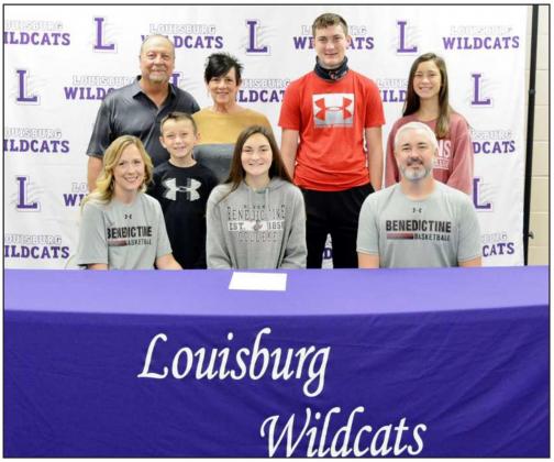 Louisburg senior Madilyn Melton signed a national letter of intent to play basketball at Benedictine College. Pictured with Madilyn are (in front, from left) her mom, Meghan, little brother, Adly, and her father, Andy; (back row) grandparents, Eddie and Vicki Surrett, brother, Jaymes, and sister, Zyleigh. (Photo by Doug Carder)