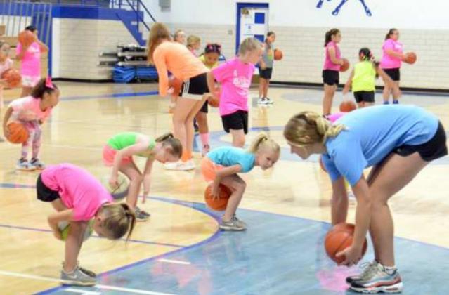 Coach Huseman had the girls of session two practice rolling the ball around their ankles, knees and waist. Volunteers Makenly “Mac” Smith (bottom right) and Analise Ramage (top left) were showing the girls how to do it.