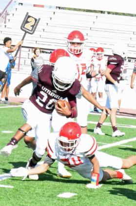JUKING THE DEFENSE – Littlefield JV running back, Zane Champion (20), side steps a Denver City defender on his way to a solid pick-up for the Wildcats, during their, 20-14, victory over the Mustangs on Thursday at Wildcat Stadium in Littlefield. (Staff Photo by Derek Lopez)