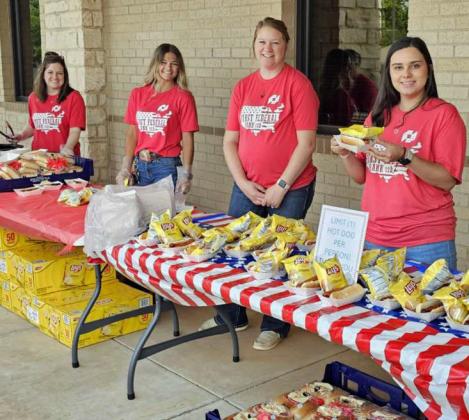 Members of the First Federal Bank team served free hot dogs and chips to attendees of their 3rd of July event last Thursday. (Staff Photo by Derek Lopez)