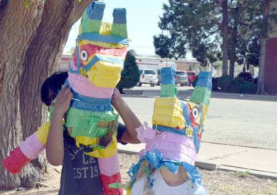 CELEBRATING PINATA DAY -- These two young people were “horsing around” a little following the Pinata event at the Lamb County Library held on Tuesday, April 18, 2023. (Photo by Ann Reagan)