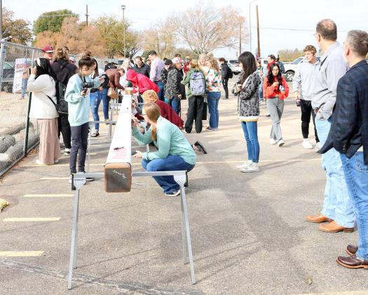 The large beams were signed by many Littlefield residents and alumni at the steele signing ceremony for the new high school construction in progress on Friday, November 17,2023. (Photo by Ann Reagan)