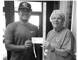 Former Littlefield High School student, Jordan Trevino, receives a scholarship check for the fall semester from Doris Howell of the Lamb Healthcare Auxiliary. (Submitted Photo)