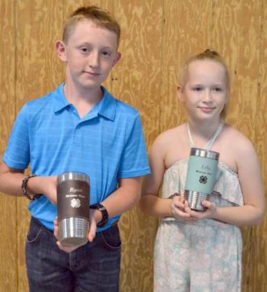 BRONZE STAR AWARDS – Ryan Muller and Lillian Burt hold their special award mugs. The Bronze Star Award is the highest honor a 4-H member in third grade thru fifth grades can receive, according to their 4-H involvement, leadership, community service, composure and confidence. (Staff Photo by Joella Lovvorn)