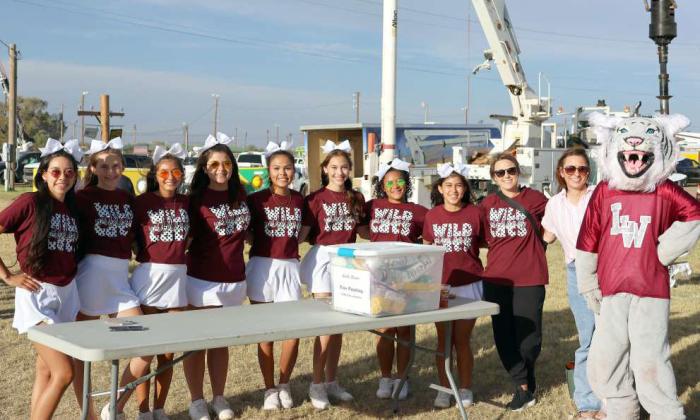 The 2024-2025 Litttlefield Wildcat Cheerleading squad from left to right- Adrianna Caudillo, Piper Carr, Brianna Martinez, Jaelyn Tijerina, Alexis Garza, Aleigha Camargo, Amaya McCanick, Arian MacDonald, Coach Trisha Nelson, Coach Alana Carr, and Mascot Rhealee Golden. The squad provided a face painting booth for the youngsters attending the Annual LCEC Business Meeting at the Lamb County Ag Center. (Photo by Ann Reagan)