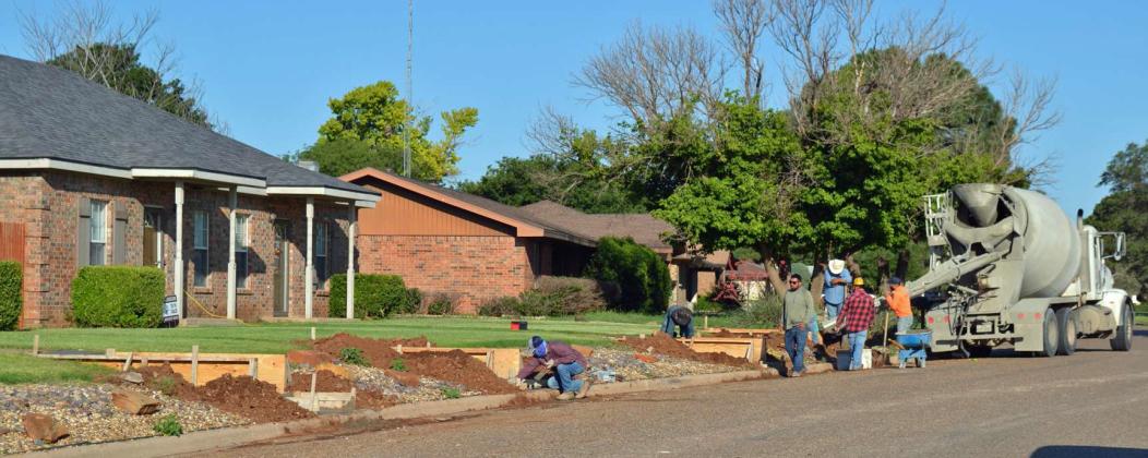 Leo Santellano leads a construction crew as they lay new steps for safety purposes in Littlefield. He was contracted by Eric Turpen. (Staff Photo by Grata Reber)
